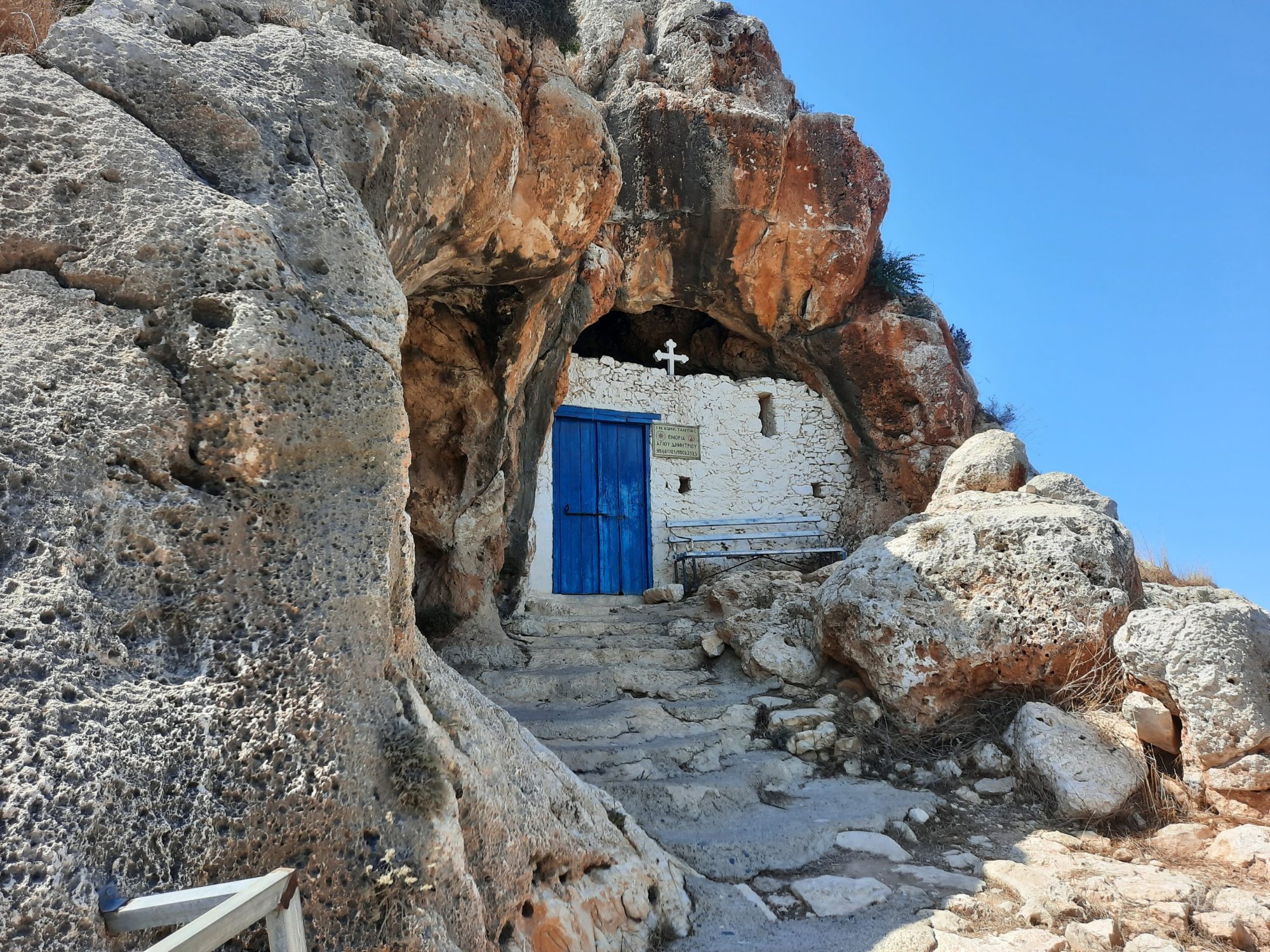 Agioi Saranta cave chapel — ancient church built into the rock face with blue door