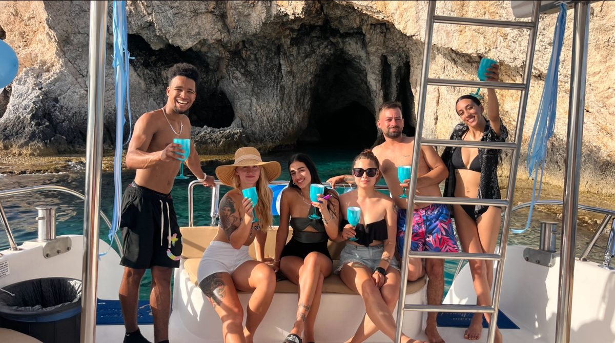 Small group enjoying drinks at sea caves on private charter Ayia Napa