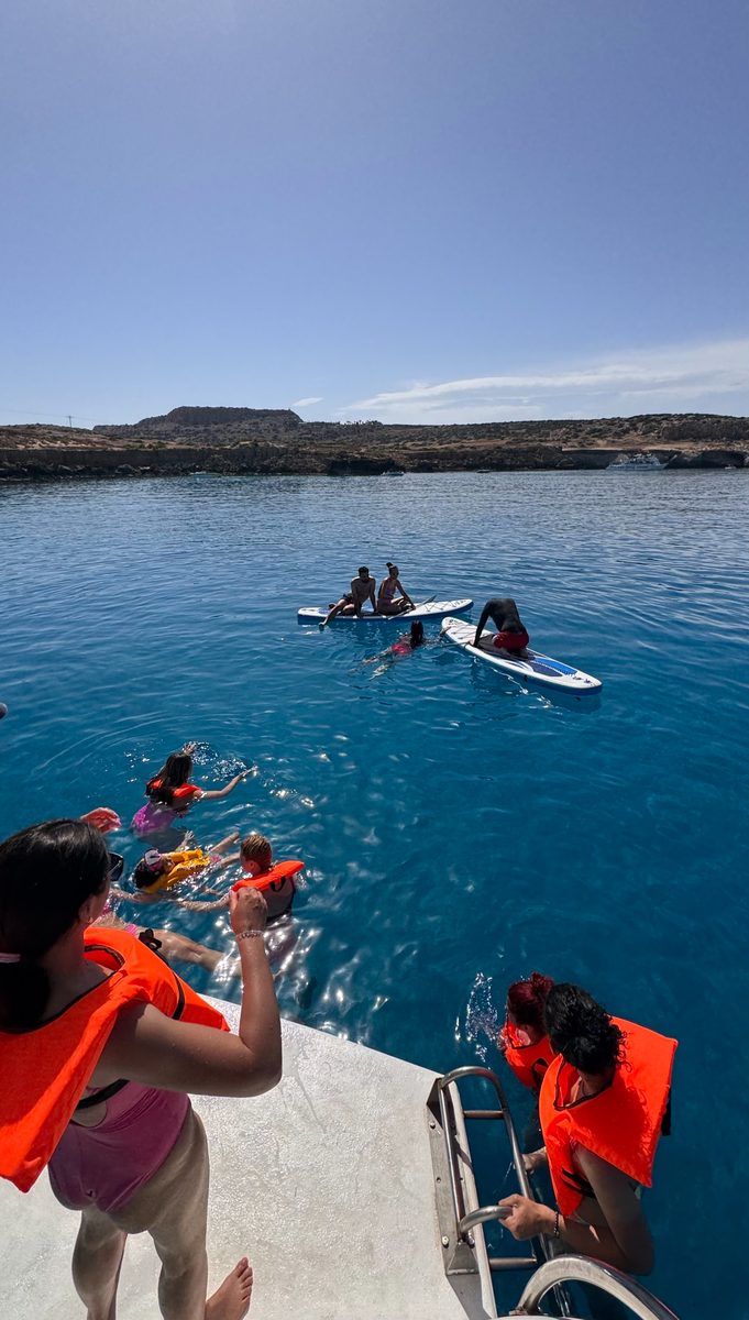 Guests swimming and using SUP from private charter boat Ayia Napa